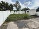 Backyard with a shed, a white fence, and concrete patio needs some yard work at 7104 Blue Earth Ct, Orlando, FL 32818