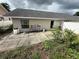 A view of the back of the home with a patio area at 7104 Blue Earth Ct, Orlando, FL 32818