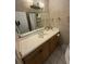 Bathroom with vanity, mirror, and neutral tiles at 7104 Blue Earth Ct, Orlando, FL 32818