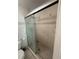 Shower with tiled walls and sliding glass door with handle at 7104 Blue Earth Ct, Orlando, FL 32818