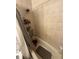 Tiled bathroom with bathtub and shower, featuring shower rack and a rubber bath mat at 7104 Blue Earth Ct, Orlando, FL 32818