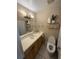 Bathroom with vanity, plant, and toilet, featuring neutral tile and lots of counter space at 7104 Blue Earth Ct, Orlando, FL 32818