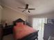 Bedroom featuring neutral walls, a ceiling fan, tile floors, and a dark wood bedroom set with bed and dressers at 7104 Blue Earth Ct, Orlando, FL 32818