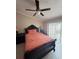 Bedroom featuring neutral walls, a ceiling fan, tile floors, and a dark wood bedroom set with bed and side tables at 7104 Blue Earth Ct, Orlando, FL 32818