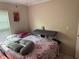 Cozy bedroom with floral bedding and natural light at 7104 Blue Earth Ct, Orlando, FL 32818