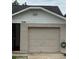Attached one car garage with a door and house number 7104, with a brick facade under a white roof at 7104 Blue Earth Ct, Orlando, FL 32818