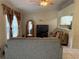 Cozy living room has open layout into kitchen with ceiling fan and tile flooring at 7104 Blue Earth Ct, Orlando, FL 32818