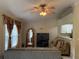 Cozy living room has open layout into kitchen with ceiling fan and tile flooring at 7104 Blue Earth Ct, Orlando, FL 32818