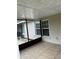 Screen enclosed porch with tile floor and view of windows with white shutters and brown framing at 7104 Blue Earth Ct, Orlando, FL 32818