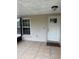 Covered front porch with tile floor, white front door with window, and a window to the left at 7104 Blue Earth Ct, Orlando, FL 32818