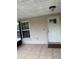 Covered front porch with tile floor, white front door with window, and a window to the left at 7104 Blue Earth Ct, Orlando, FL 32818