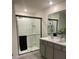 Bathroom with a glass-enclosed shower, gray vanity, and modern fixtures at 7172 Sw 135Th Pl, Ocala, FL 34473