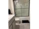 Clean bathroom showcasing tiled shower with sliding door, commode, and modern vanity at 7172 Sw 135Th Pl, Ocala, FL 34473