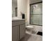 Stylish bathroom with modern vanity, commode, and tiled shower with sliding door at 7172 Sw 135Th Pl, Ocala, FL 34473