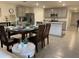 Inviting dining area featuring a dark wood table set for four with gray kitchen cabinets and stainless steel appliances at 7172 Sw 135Th Pl, Ocala, FL 34473
