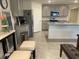 A well-lit kitchen features gray cabinets, stainless steel appliances, and a practical layout at 7172 Sw 135Th Pl, Ocala, FL 34473
