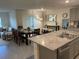 Open-concept kitchen flows into the dining and living areas with modern finishes at 7172 Sw 135Th Pl, Ocala, FL 34473