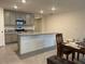 Open kitchen featuring gray cabinets, granite countertops, and stainless steel appliances at 7172 Sw 135Th Pl, Ocala, FL 34473
