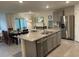 Modern kitchen with granite counters, stainless steel appliances, and an island sink at 7172 Sw 135Th Pl, Ocala, FL 34473