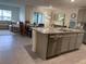 Open-concept kitchen flows into the dining and living areas with modern finishes at 7172 Sw 135Th Pl, Ocala, FL 34473