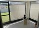 The cozy sunroom is surrounded by windows, offering a peaceful view of the outdoors at 7172 Sw 135Th Pl, Ocala, FL 34473