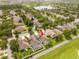 Aerial view of a home with a screened pool in a community with green spaces and other homes at 7214 Tattant Blvd, Windermere, FL 34786