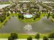 Community aerial view of a lake with a fountain surrounded by trees and homes at 7214 Tattant Blvd, Windermere, FL 34786