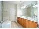 Bathroom with double sink vanity, large mirror, and tile flooring at 7214 Tattant Blvd, Windermere, FL 34786