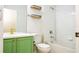 Bathroom with green vanity, shelving and a bathtub at 7214 Tattant Blvd, Windermere, FL 34786