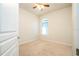 Carpeted bedroom with ceiling fan, window and blinds, and white walls offering a clean space at 7214 Tattant Blvd, Windermere, FL 34786