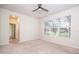 Cozy bedroom featuring a ceiling fan and large window for natural light at 7214 Tattant Blvd, Windermere, FL 34786