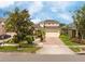 Charming home features a well-manicured lawn, brick driveway, and inviting facade at 7214 Tattant Blvd, Windermere, FL 34786