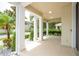 Inviting covered front porch with white pillars, lush landscaping, and ample space for seating at 7214 Tattant Blvd, Windermere, FL 34786
