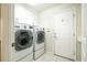 Bright laundry room with modern LG washer and dryer units, and ample cabinetry for organized storage at 7214 Tattant Blvd, Windermere, FL 34786