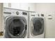 Laundry room featuring LG machines and overhead cabinets at 7214 Tattant Blvd, Windermere, FL 34786