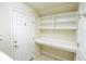A laundry room with built-in shelves and a counter, offering convenience and storage space at 7214 Tattant Blvd, Windermere, FL 34786