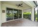 Relaxing covered patio with ceiling fan, with brick flooring, providing shade and space for outdoor enjoyment at 7214 Tattant Blvd, Windermere, FL 34786