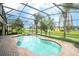 Screened-in pool area offering a serene retreat with lush landscaping and space for outdoor lounging and entertainment at 7214 Tattant Blvd, Windermere, FL 34786
