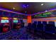 Fun-filled arcade room featuring classic games, neon lights, and cinema-style seating, perfect for entertainment and recreation at 884 Golden Bear Dr, Reunion, FL 34747