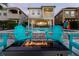 Relaxing backyard with a pool, fire pit, lake view, patio furniture, and playful games for ultimate outdoor enjoyment at 884 Golden Bear Dr, Reunion, FL 34747