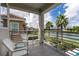 Balcony view overlooking lake with seating, and decorative metal railing at 884 Golden Bear Dr, Reunion, FL 34747