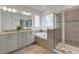 This bathroom has double sinks, garden tub, and a glass enclosed shower with tile surround at 884 Golden Bear Dr, Reunion, FL 34747