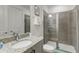 Modern bathroom featuring a glass shower, granite vanity and modern fixtures at 884 Golden Bear Dr, Reunion, FL 34747
