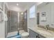 Bathroom featuring a glass shower, granite vanity and modern fixtures at 884 Golden Bear Dr, Reunion, FL 34747