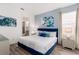 Comfortable bedroom features stylish blue accents and ensuite bathroom at 884 Golden Bear Dr, Reunion, FL 34747