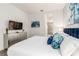 Comfortable bedroom with stylish blue accents and ensuite bathroom view at 884 Golden Bear Dr, Reunion, FL 34747