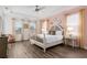 The main bedroom features hard wood floors, a ceiling fan, and many windows at 884 Golden Bear Dr, Reunion, FL 34747
