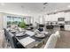 Open-concept dining area with seating for ten, adjacent to the kitchen and overlooking the pool at 884 Golden Bear Dr, Reunion, FL 34747