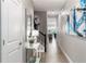 Bright hallway featuring stylish décor, modern lighting, neutral tones, and tiled flooring, creating an inviting entrance at 884 Golden Bear Dr, Reunion, FL 34747