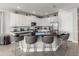 Kitchen island featuring bar stool seating and a sink, set against a backdrop of white cabinetry at 884 Golden Bear Dr, Reunion, FL 34747